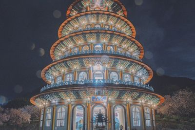 Low angle view of illuminated building at night