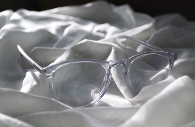 Close-up of eyeglasses on crumpled sheet