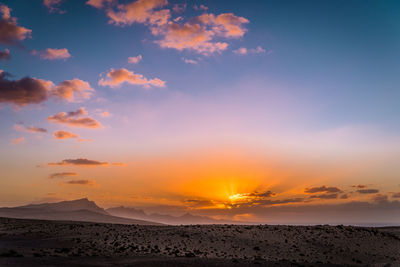 Scenic view of landscape against sky during sunset