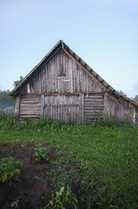 Barn on field against clear sky