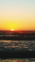 Scenic view of sea against romantic sky at sunset