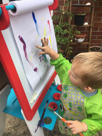 High angle view of boy painting