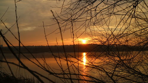 Scenic view of lake against orange sky