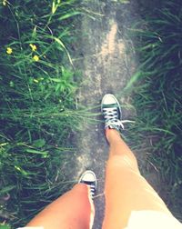 Low section of woman standing on grass