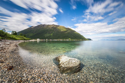 Sea with mountain in background