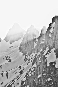 Scenic view of snowcapped mountains against clear sky