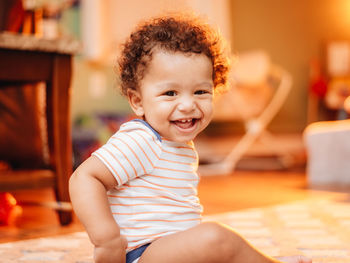 Portrait of smiling boy sitting at home