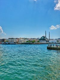 Scenic view of sea and buildings against sky