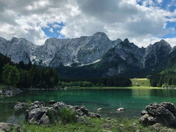 Scenic view of lake and mountains against sky