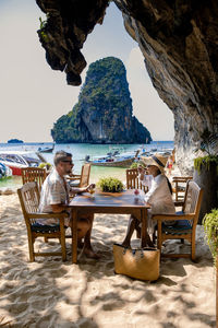 Chairs and tables sitting on table at beach