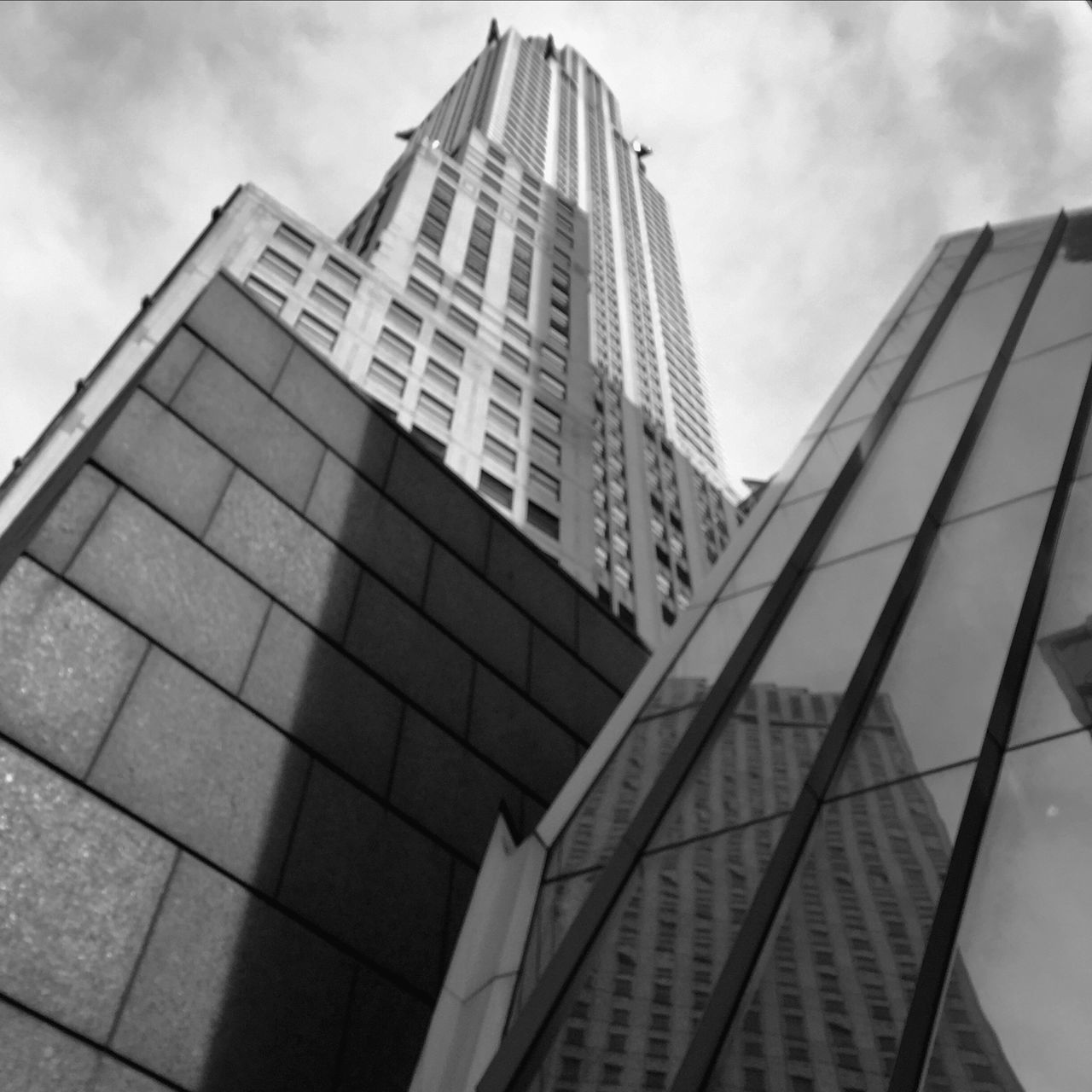 architecture, building exterior, built structure, low angle view, modern, office building, sky, city, tall - high, skyscraper, glass - material, tower, building, reflection, cloud - sky, window, day, tall, outdoors, no people