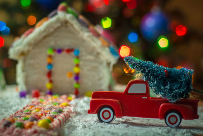 Close-up of toy car on christmas tree at night