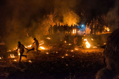 Group of people in fire at night