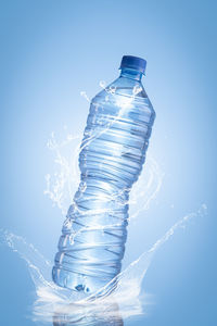 Close-up of water bottle against blue background