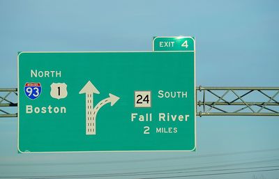 Low angle view of sign board against sky