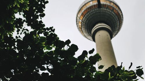 Low angle view of communications tower against sky