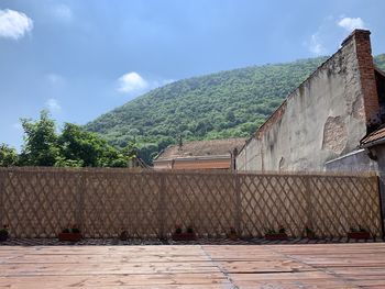 Houses on mountain against sky