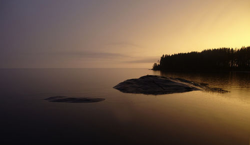 Scenic view of sea against sky at sunset