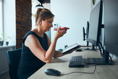 Businesswoman having business call working on tablet. manager focused on work. using technology