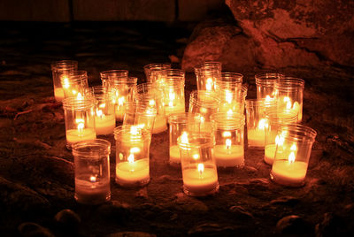 Close-up of illuminated candles in temple