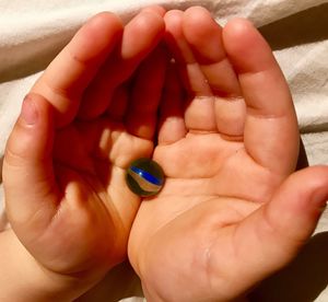 Close-up of father holding baby hand