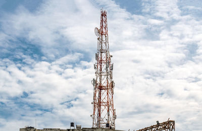 Low angle view of communications tower against sky