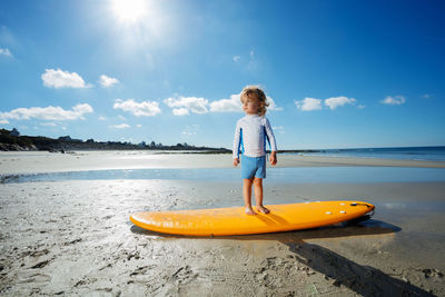 Rear view of woman in boat in sea against sky