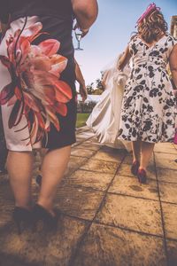 Low section of couple standing by flower