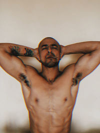 Portrait of young man with arms raised