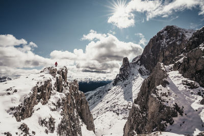 Panoramic view of snow covered mountains against sky