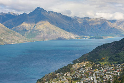 Scenic view of sea and mountains against sky