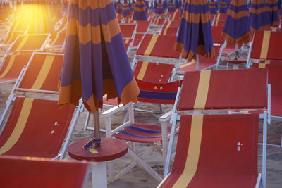 Low section of people relaxing on deck chairs