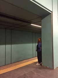 Woman standing in illuminated room