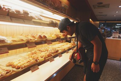 Full length of man preparing food in store