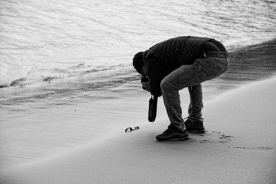 Side view of man walking on beach