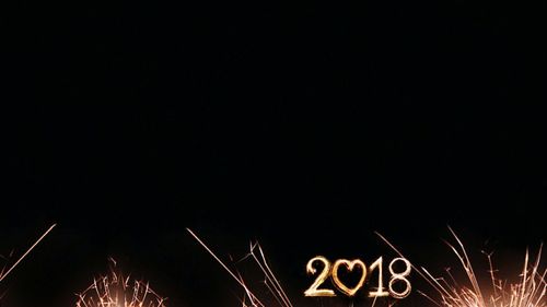 Low angle view of firework display against sky at night