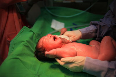 Cropped image of baby at doctors hand