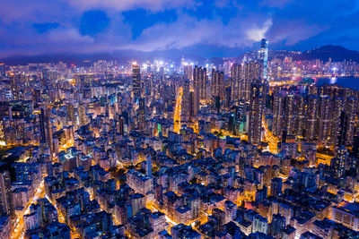 High angle view of illuminated city against sky at night