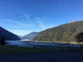 Scenic view of landscape against blue sky