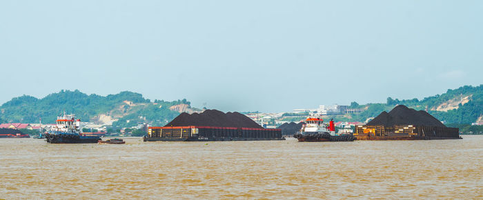 Scenic view of sea and buildings against sky