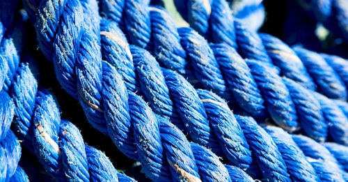 Close-up of rope tied on blue water