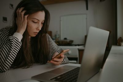 Woman watching on mobile screen with unhappy face