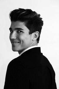 Portrait of smiling young man against white background