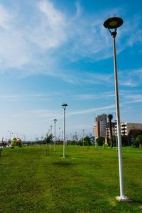 Street light on field against sky