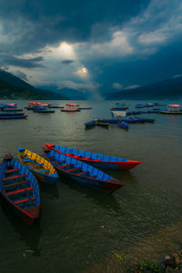 High angle view of boats moored in sea against sky