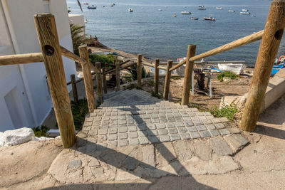 High angle view of wooden posts on beach