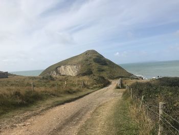 Road by sea against sky