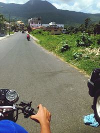 Cropped image of person on mountain road