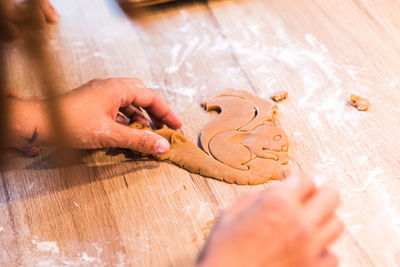 Cropped hands of person preparing food on table