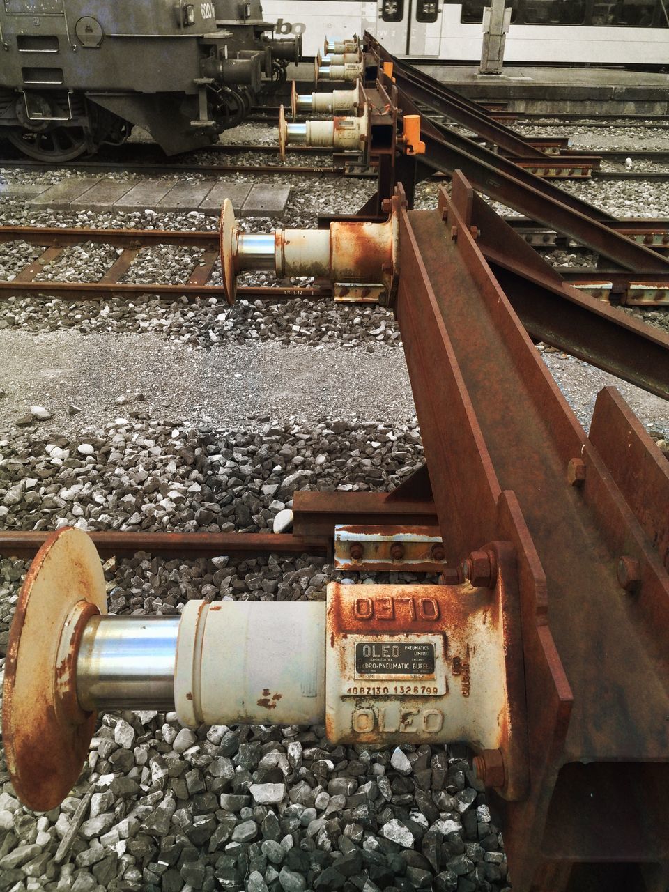 railroad track, transportation, metal, text, rusty, rail transportation, abandoned, old, obsolete, communication, day, industry, mode of transport, no people, outdoors, western script, factory, metallic, high angle view, train - vehicle